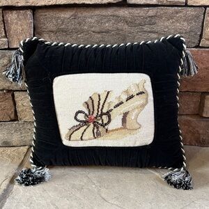 Needlepoint shoe and black velvet pillow with tassels